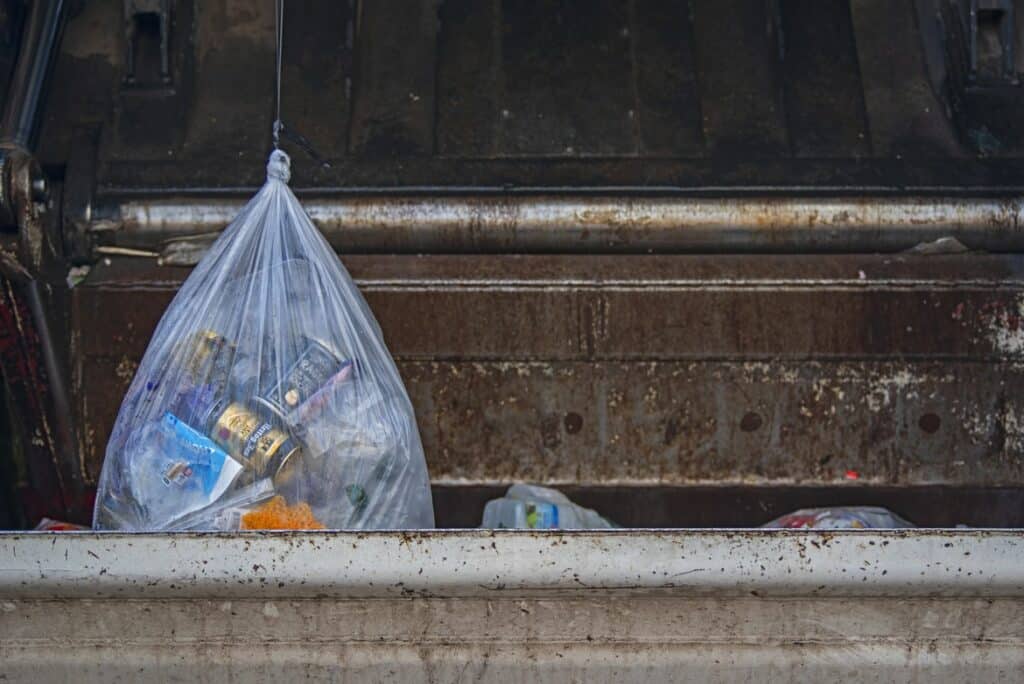 Where should you store full garbage bags?
