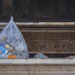 Where should you store full garbage bags?